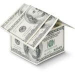 The picture shows a house constructed with currency to represent taxes you might owe when you sell.